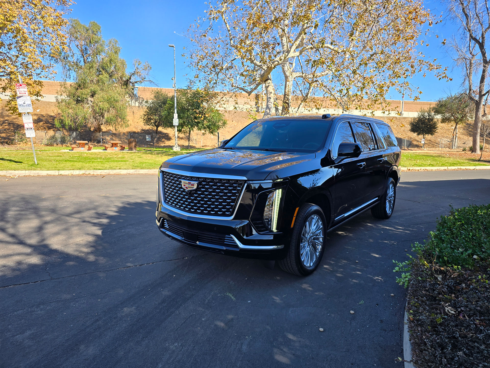 Luxury black SUV showcasing sleek design and detailed front grille, emphasizing modern elegance and performance features.